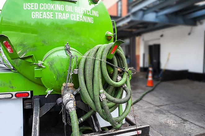 tank truck pumping out a grease trap in Deland